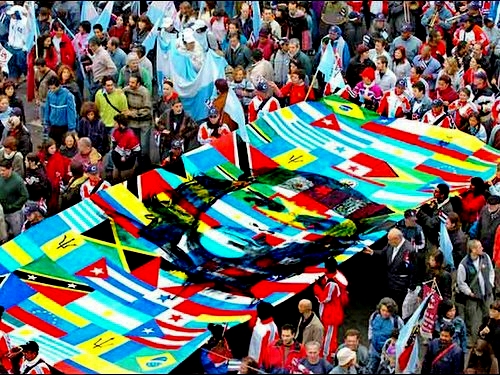 multiple parachutes with flags on them in a crowd