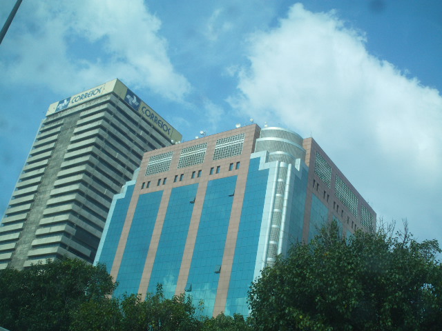 a large glass building is shown with a cloudy sky