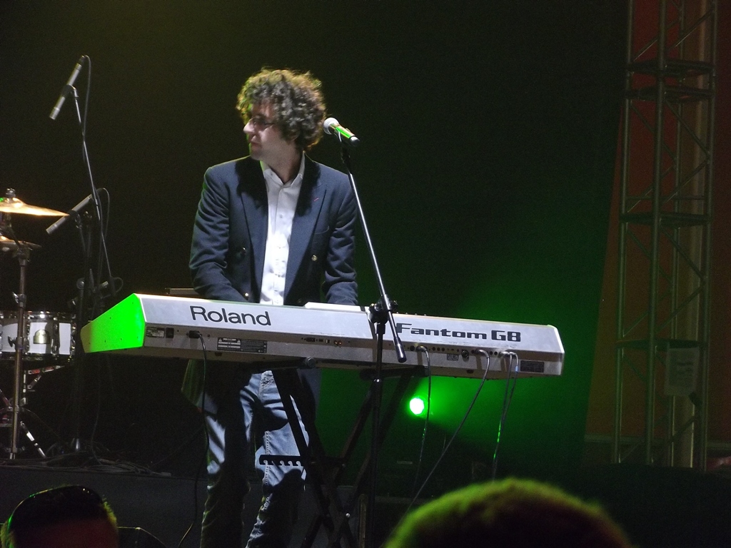 a man in black jacket playing a keyboard