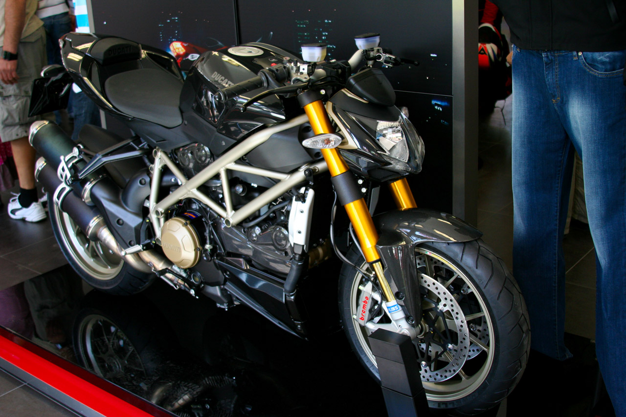 motorcycle displayed inside display in glass case at indoor area