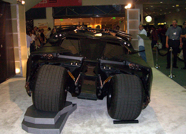 a futuristic car displayed in front of a crowd