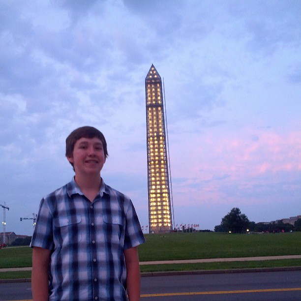 a person standing next to a tall building