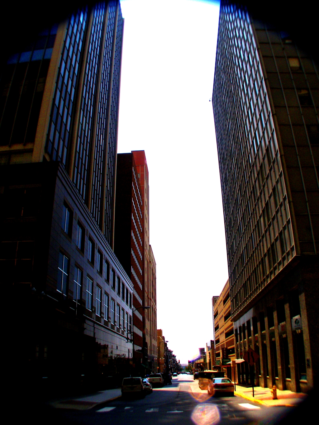 a view from the ground looking up at tall buildings