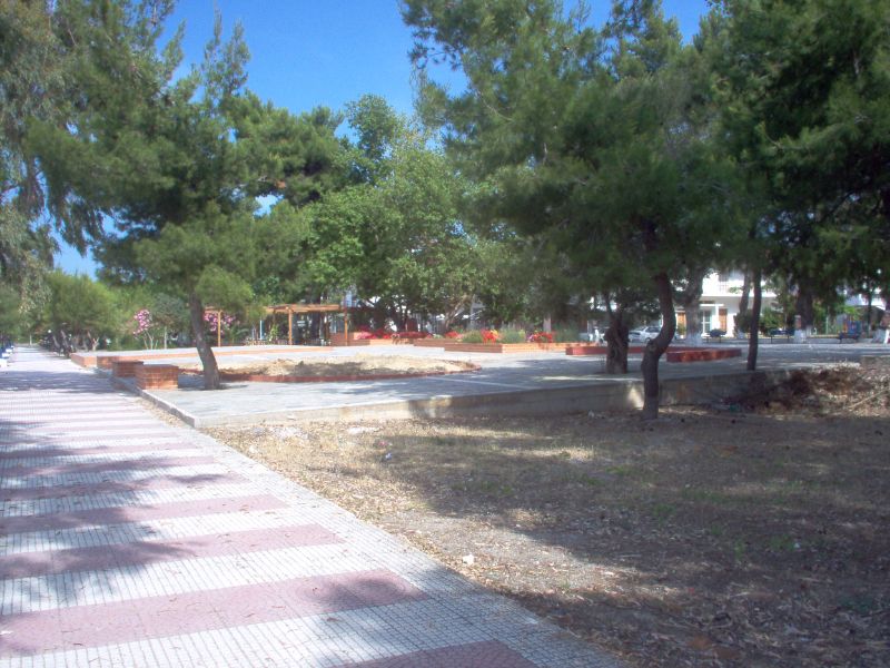 park in foreground with pink pavement on other side