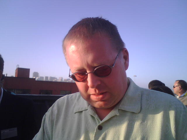 a man in sun glasses eating soing