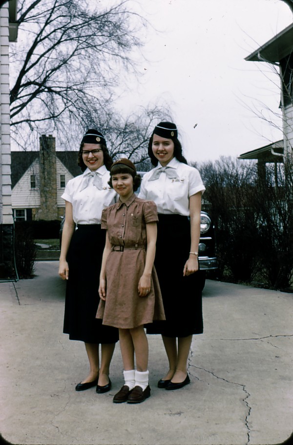 three women dressed in uniforms posing for a po