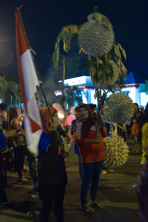 the people are holding their flags at a parade