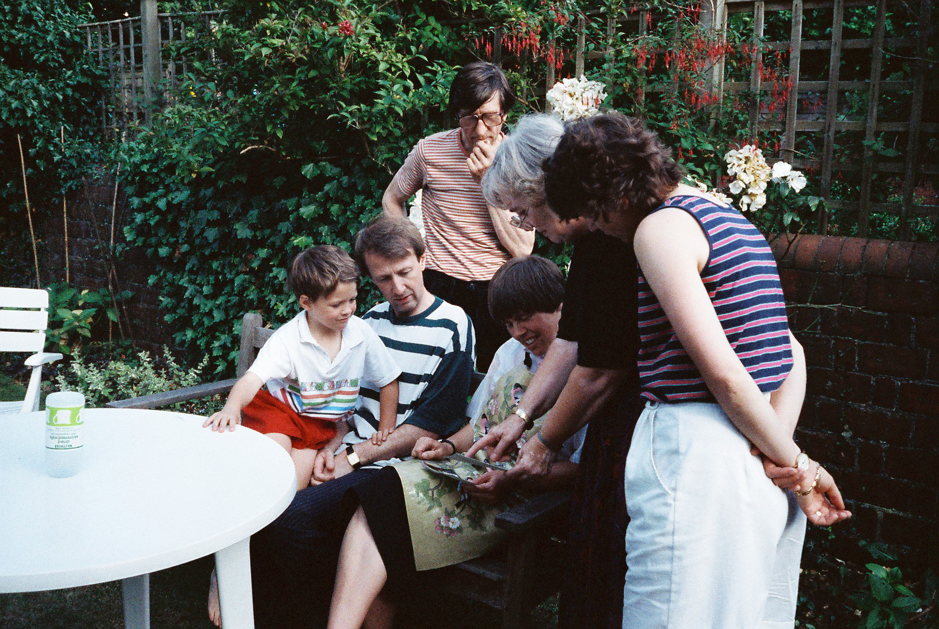 a family stands near the table looking at an image