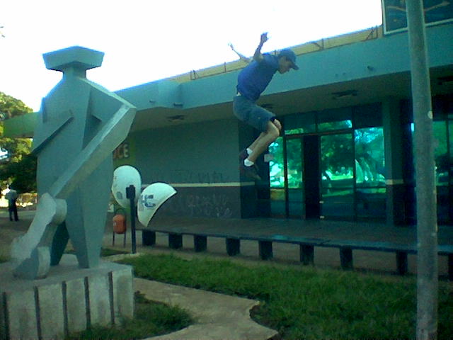 a man doing tricks on his skateboard in front of a building