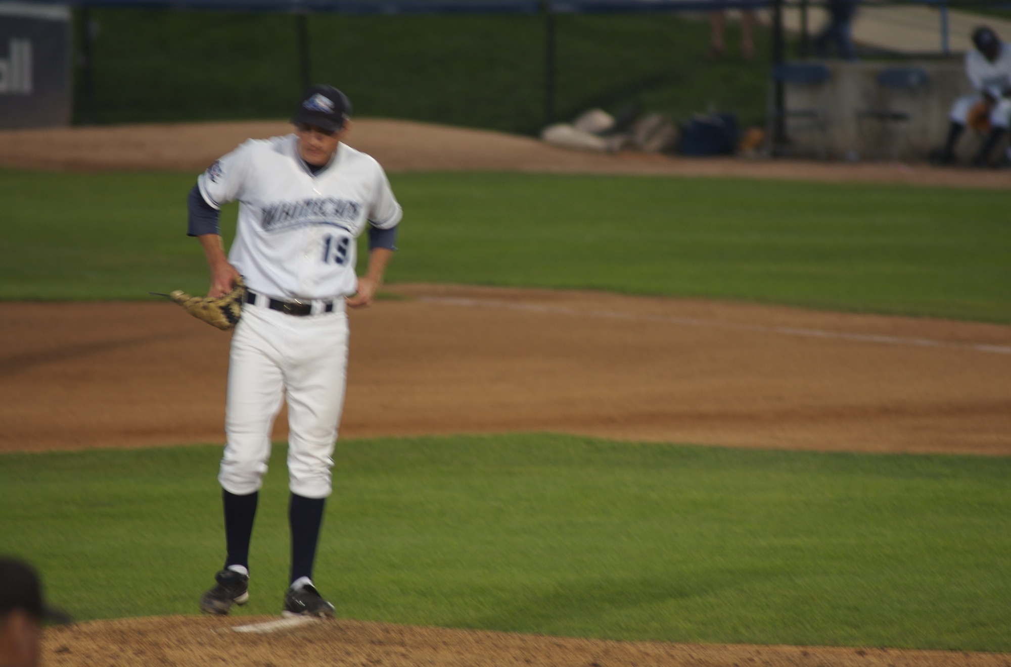 a baseball player looking at the ground during a game