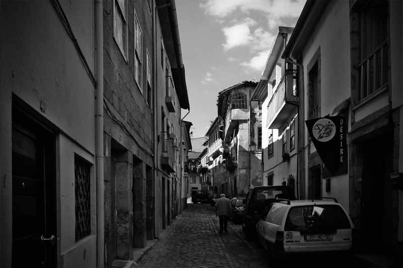 a city street with a car parked on the side