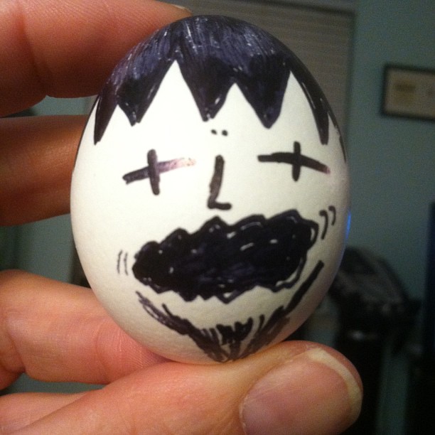 a painted egg that has a man's face on it