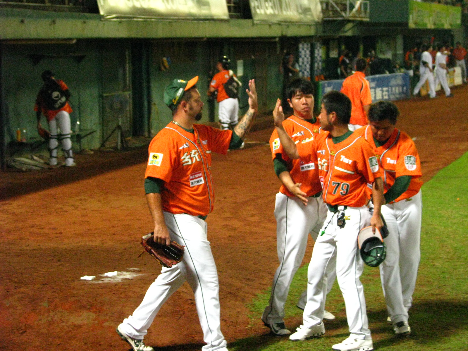 a baseball team is standing on the field talking