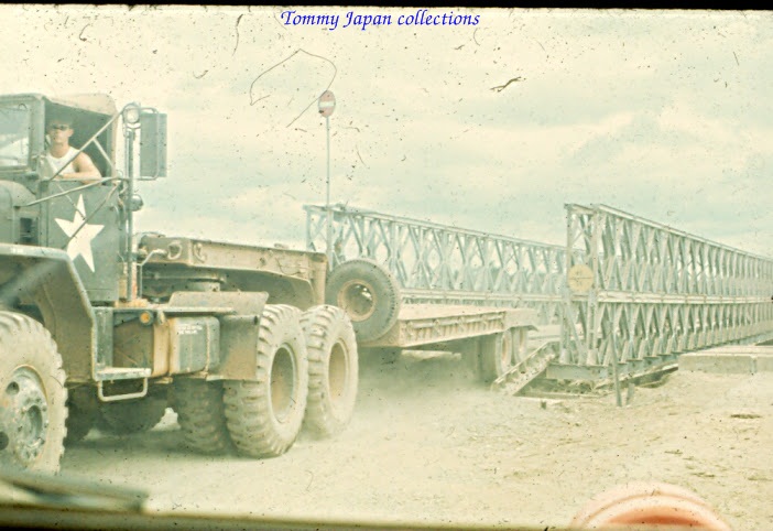 a large truck pulling a metal structure onto a beach