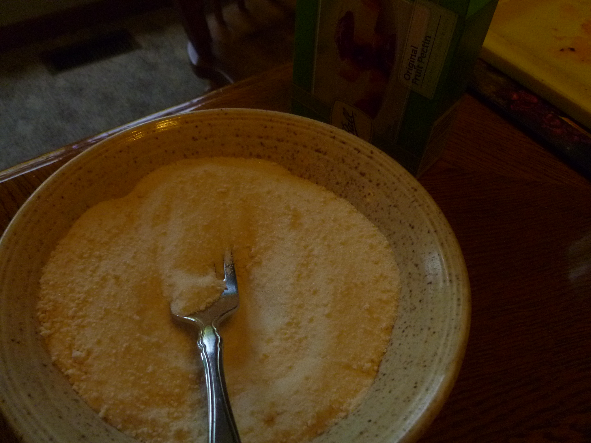 a bowl of sugar that has a fork in it