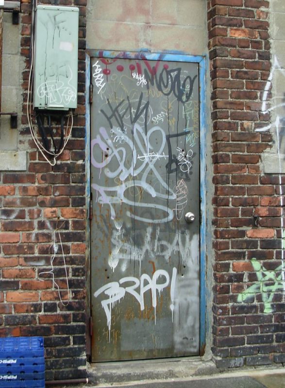 a door with graffiti all over it and on top of it