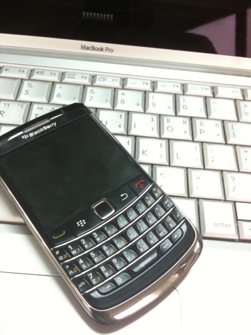 a cell phone laying on a laptop keyboard