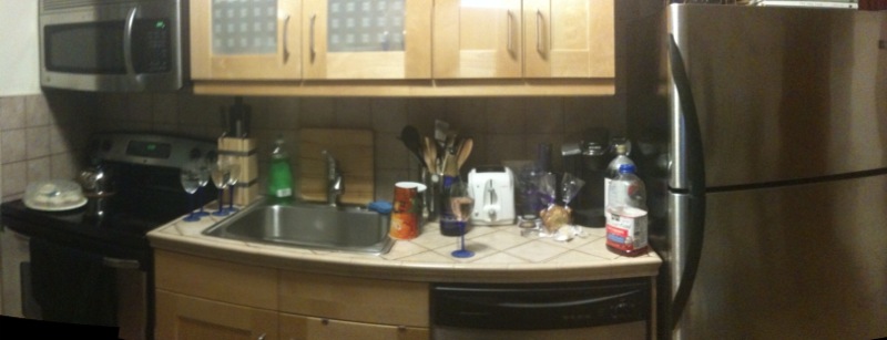 a kitchen with lots of personal objects on the counters