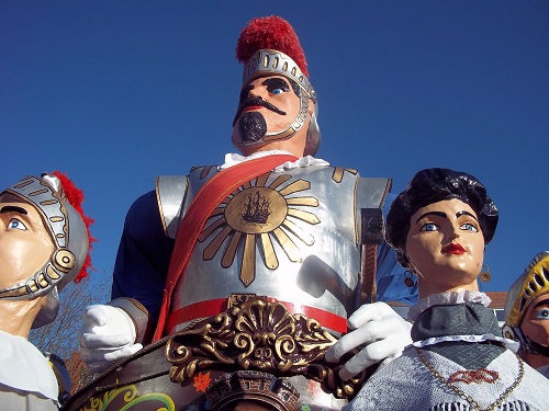 a statue of a knight surrounded by five figures