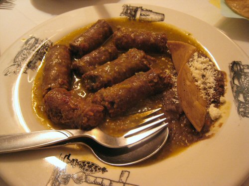 some type of meat dish with fork and knife