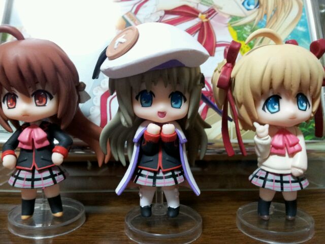three figurines wearing sailor costumes sit next to each other
