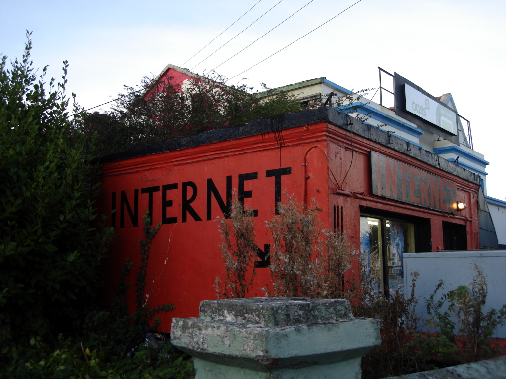 a red building with a black roof that reads internet