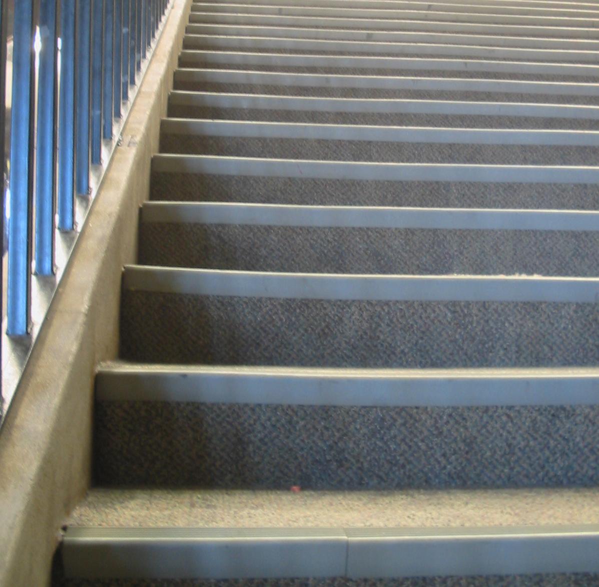 an airplane landing at the bottom of stairs