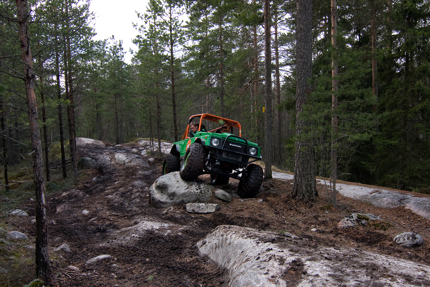 an atv is coming up on a rocky trail