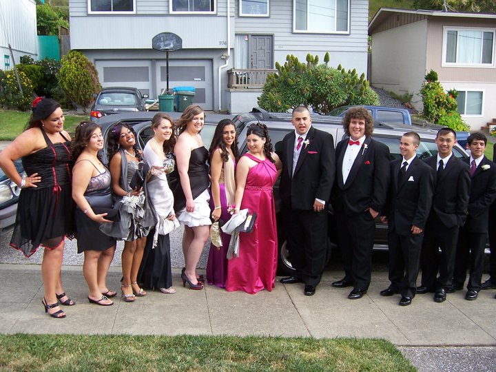 a group of people in formal wear stand together