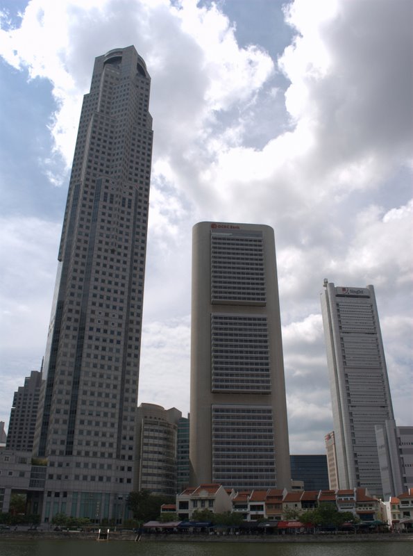 two large buildings next to a body of water