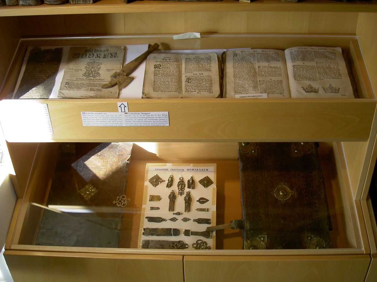an open book on display in a wooden case