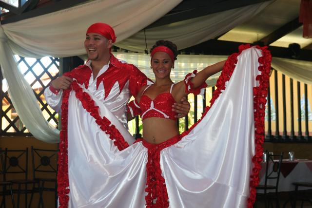 two people in costume standing by a white curtain