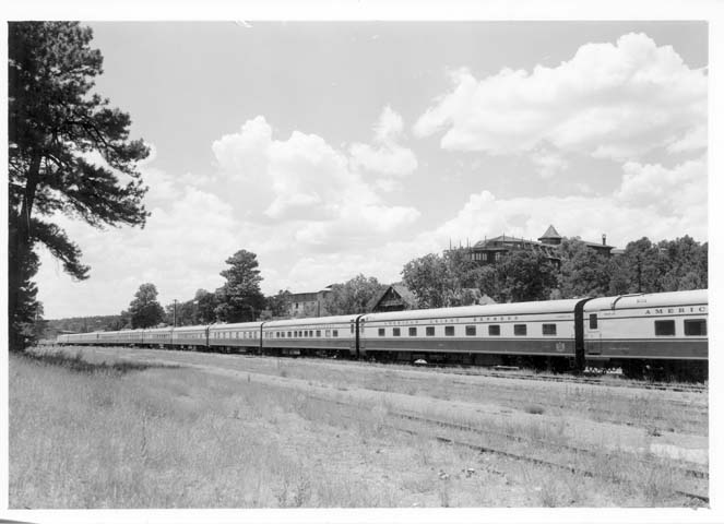a passenger train rides along an empty track