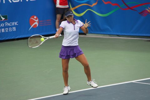a woman that is on a tennis court with a racquet