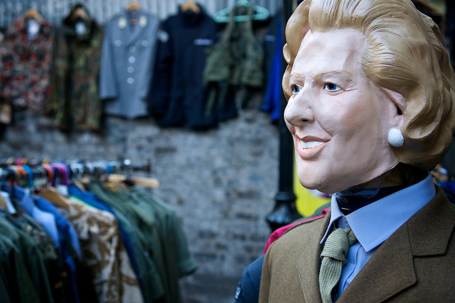 the head and collar of a dummy is next to several jackets