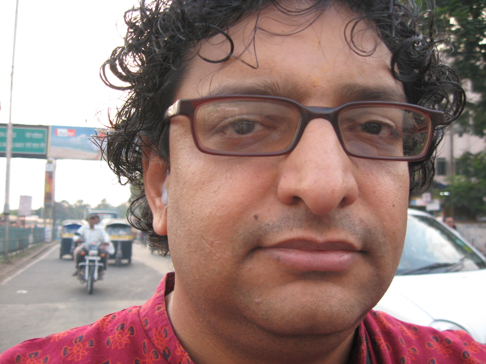 a man with glasses looking at the camera