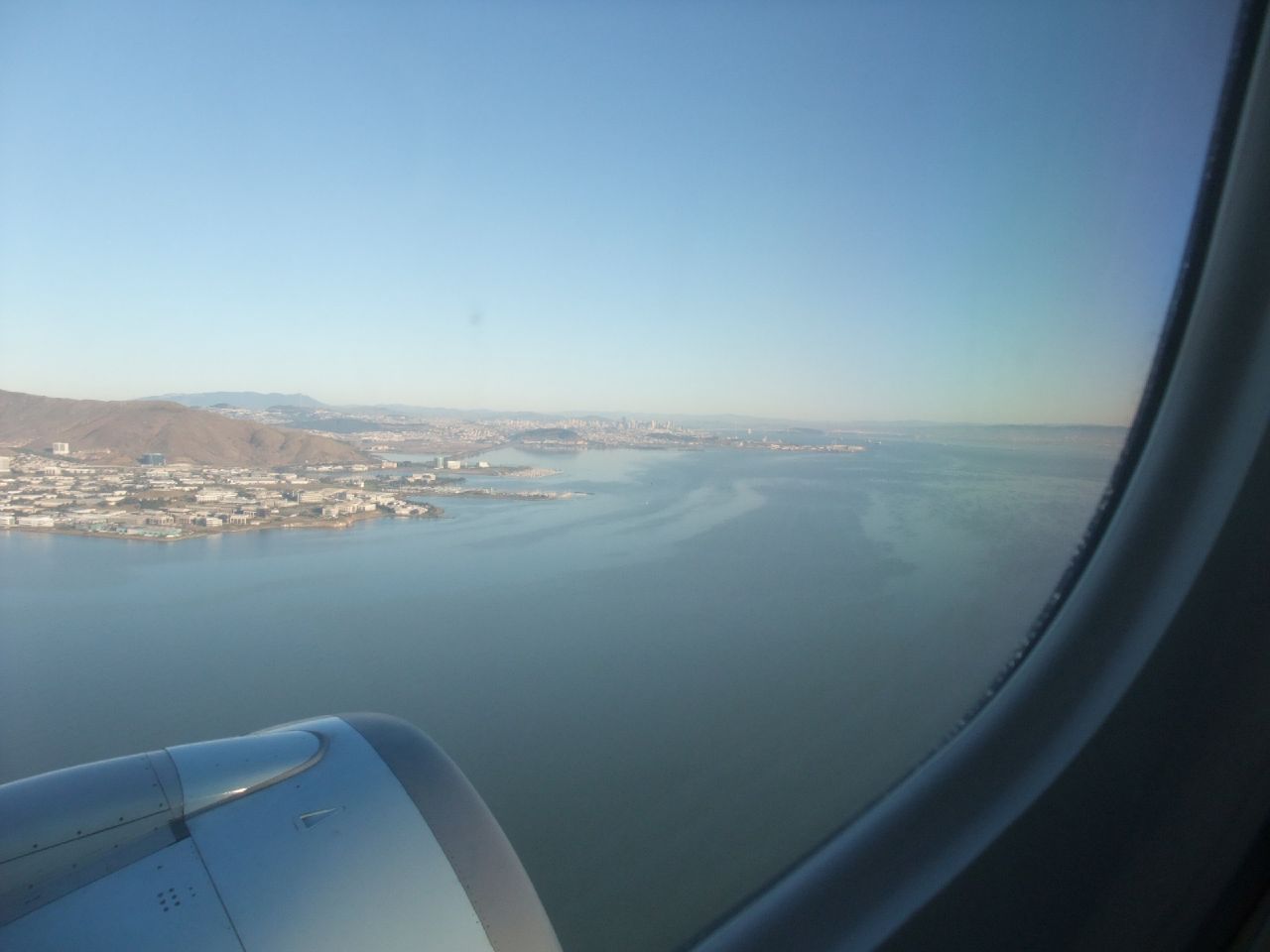 a view out an airplane window looking at the bay