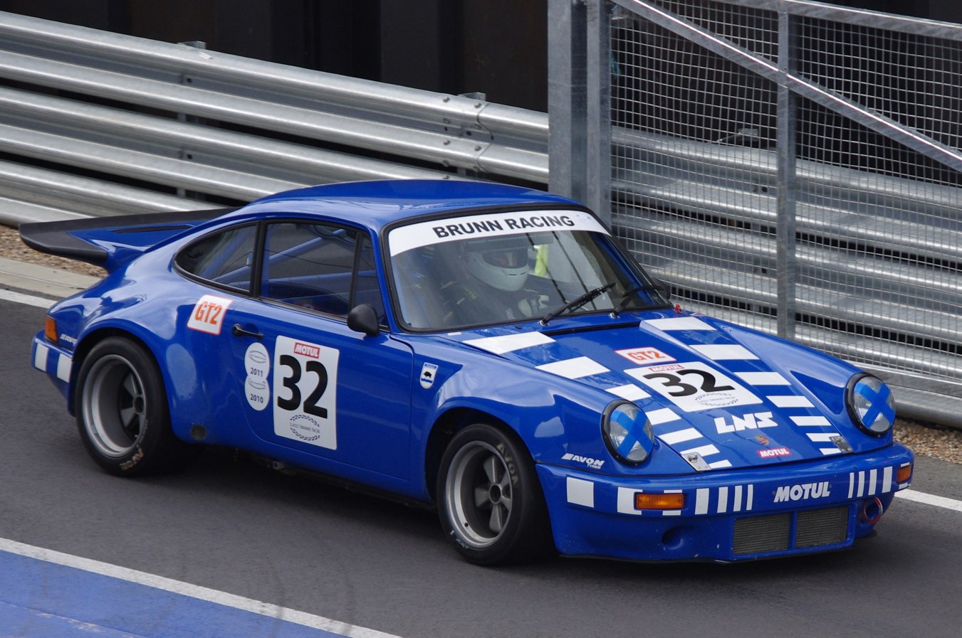 a blue racing car driving on the race track