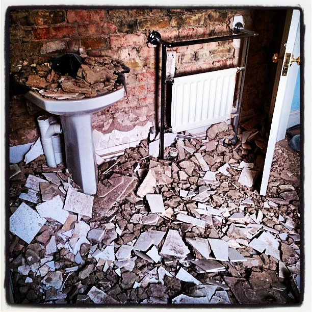 an old style bathroom with lots of debris