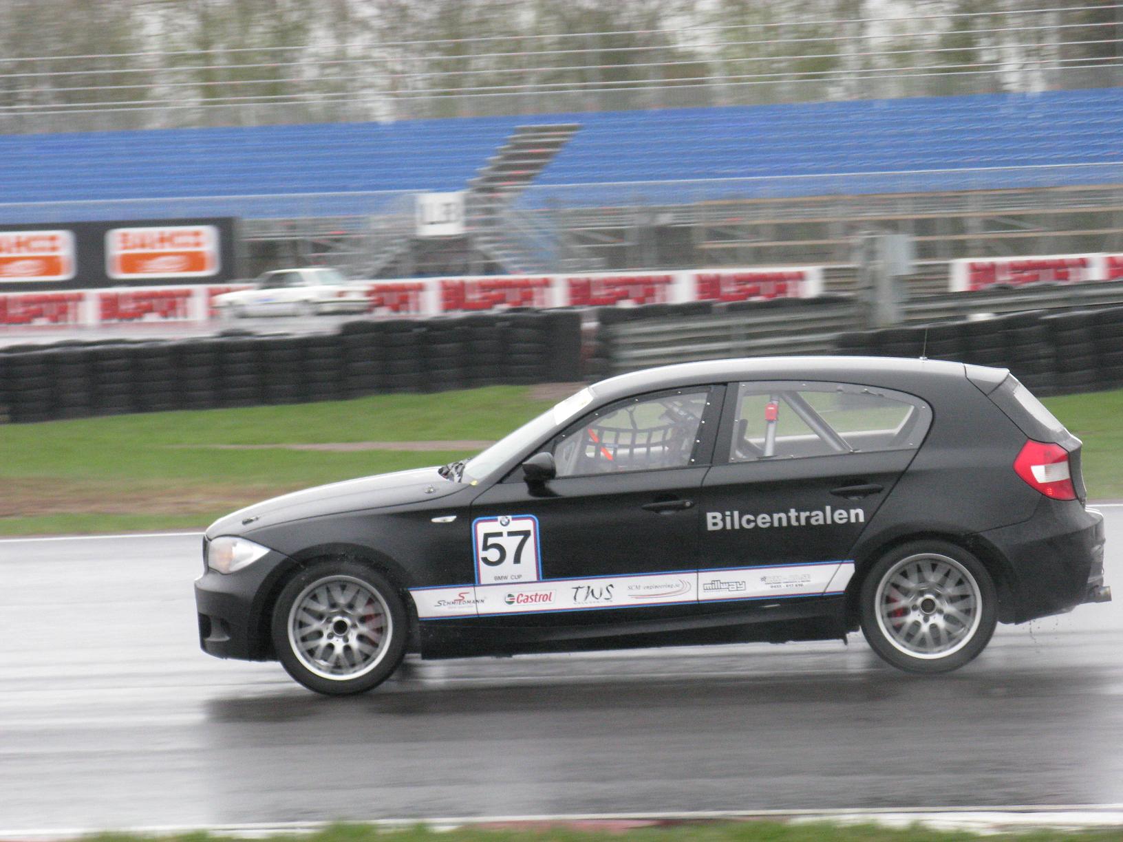 the racing car is driving on the wet track