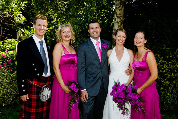 a couple with their friends in tartan and gowns