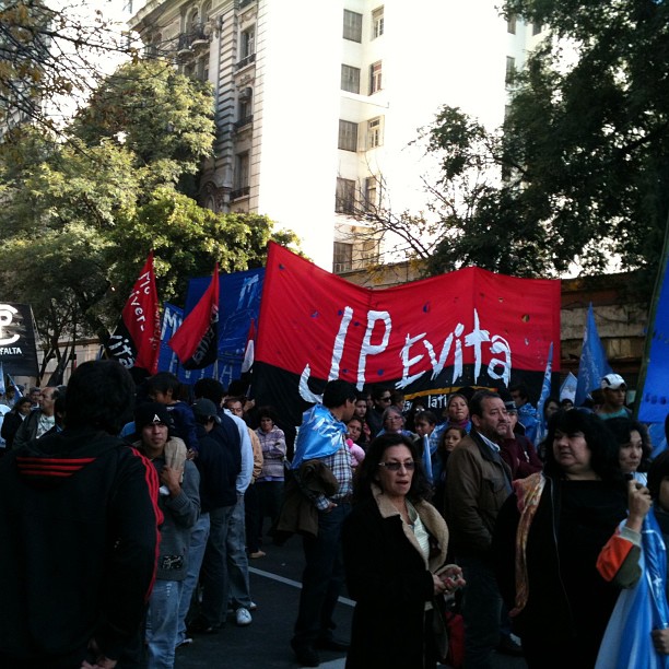 group of people holding a protest sign in the street