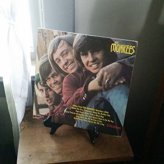 an album sitting on a wooden counter next to a window