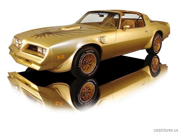 a gold pontiac car is shown on a reflective surface