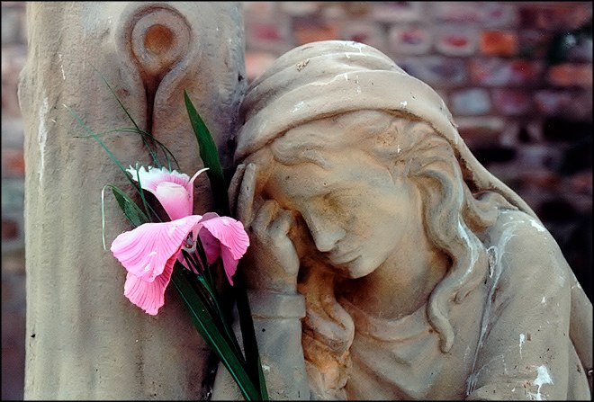 the statue holds a flower in it's mouth