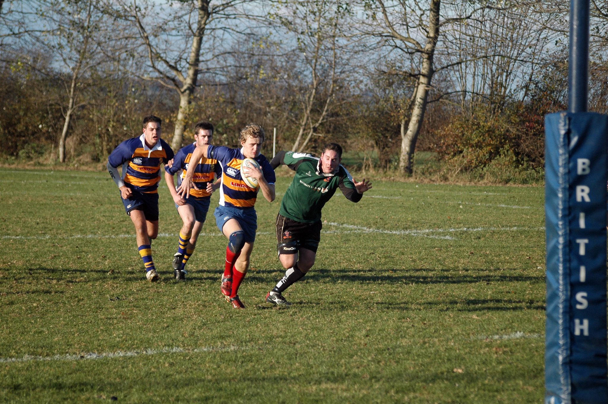 a team of young men play rugby in the field