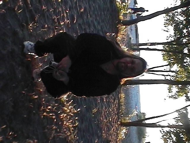 an adult male wearing a black shirt and holding a skateboard