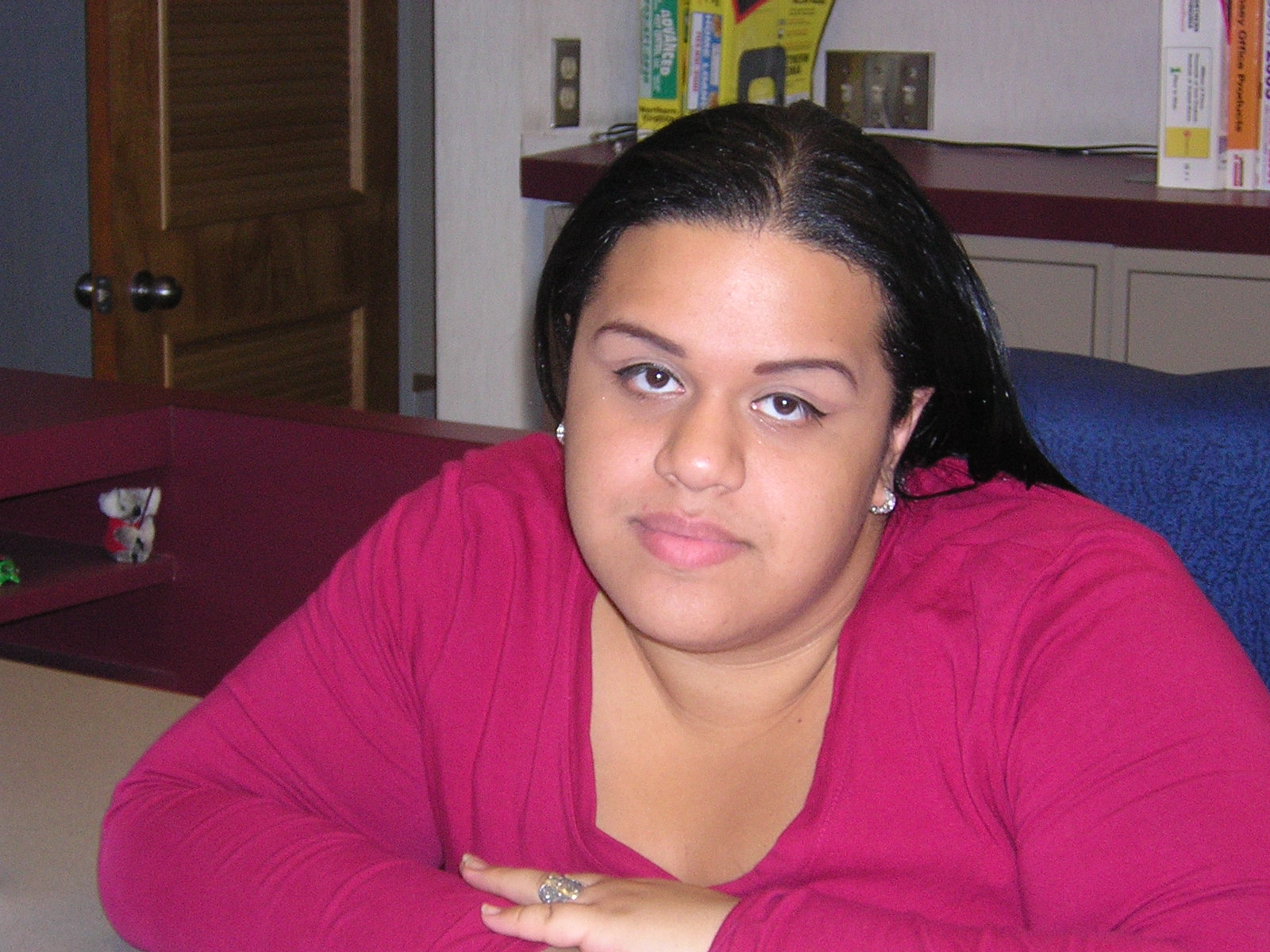 a woman is sitting down and posing for the camera