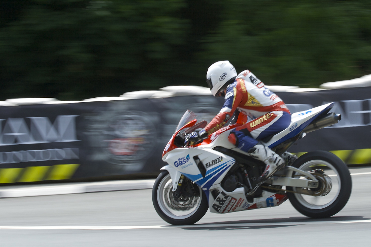 a man is riding a motorcycle on a race track