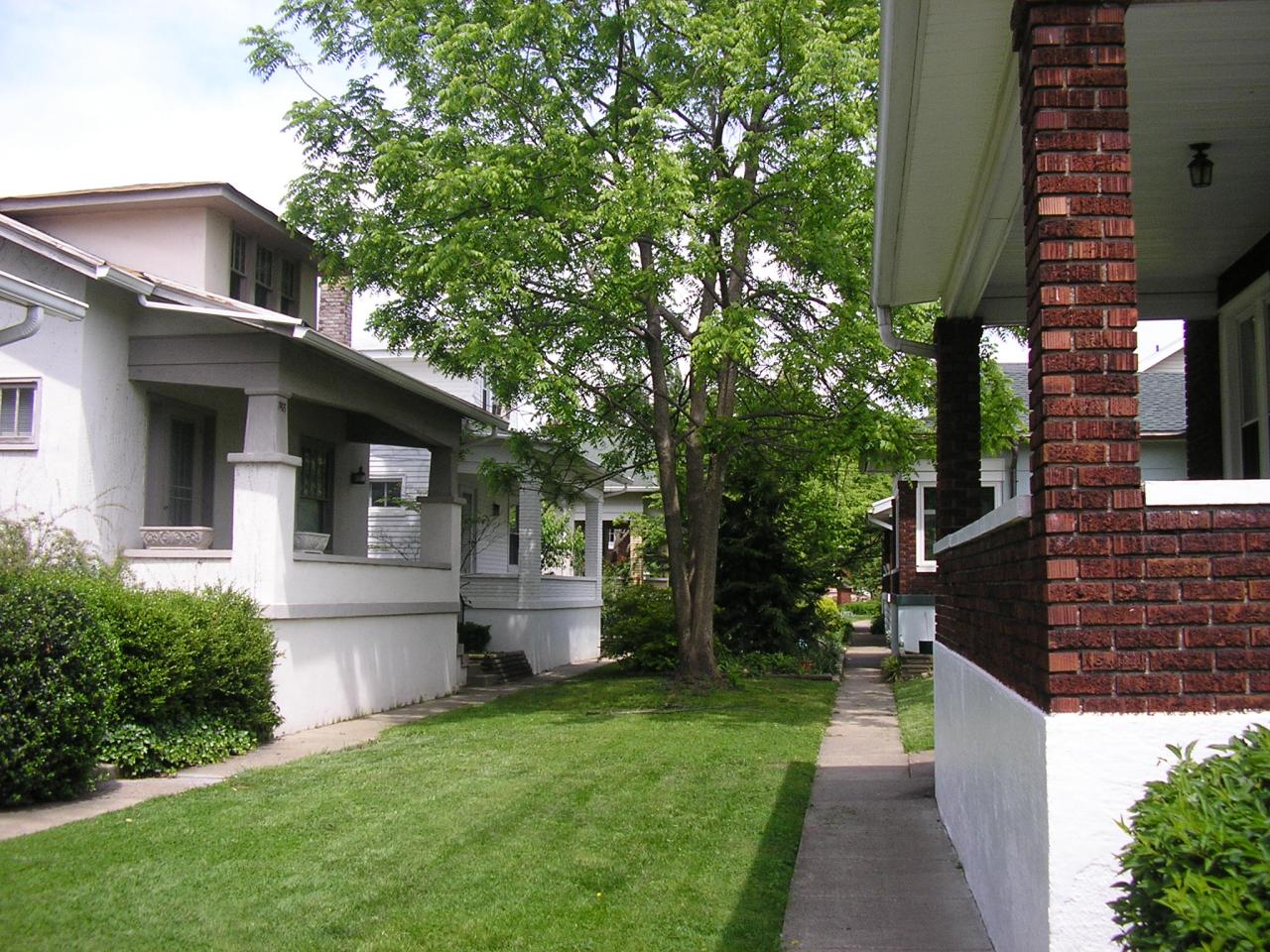 a front lawn and walkway are in the background